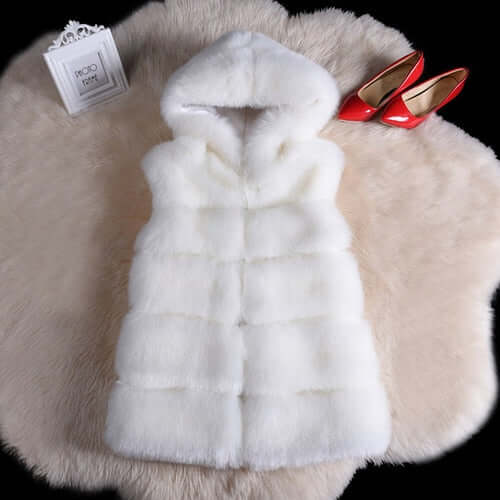 White sleeveless faux fur coat with hood on a plush background, perfect winter accessory for women.