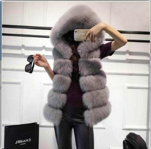 Gray sleeveless faux fur coat with hood, showcasing a stylish winter look and warm vest design for women.