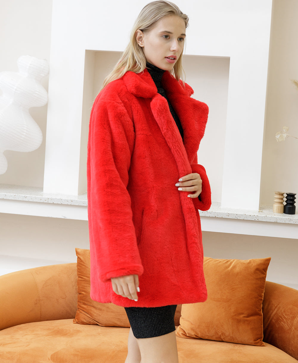 Woman in red faux fur coat, elegant and fluffy design, from 2022 Autumn Winter collection, in a stylish indoor setting.