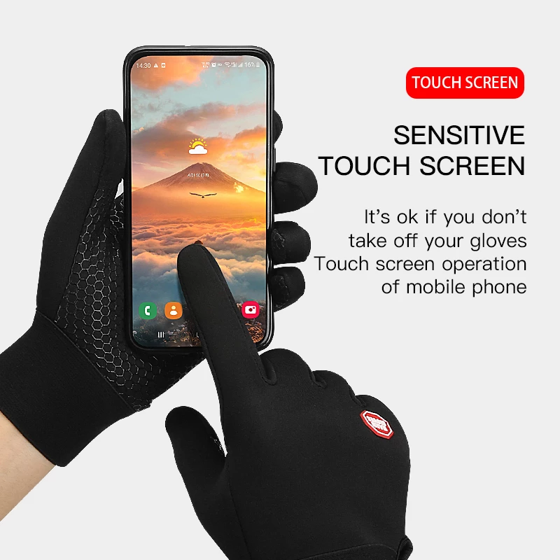 Person demonstrating the touch screen capability of thermal winter cycling gloves while holding a smartphone.