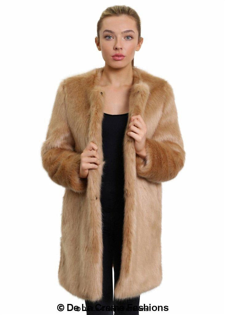 Woman modeling a De La Creme camel-colored faux fur classic coat, standing with coat open over a black dress.