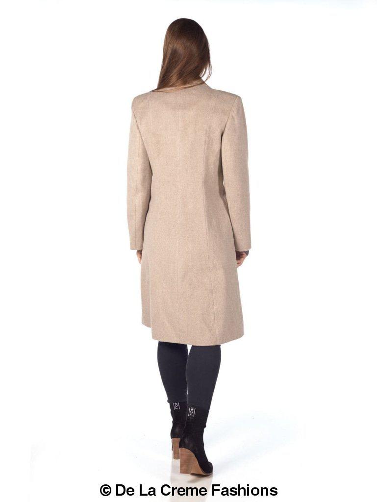 Back view of a woman wearing De La Creme mohair blend longline winter coat in beige, paired with black leggings and boots