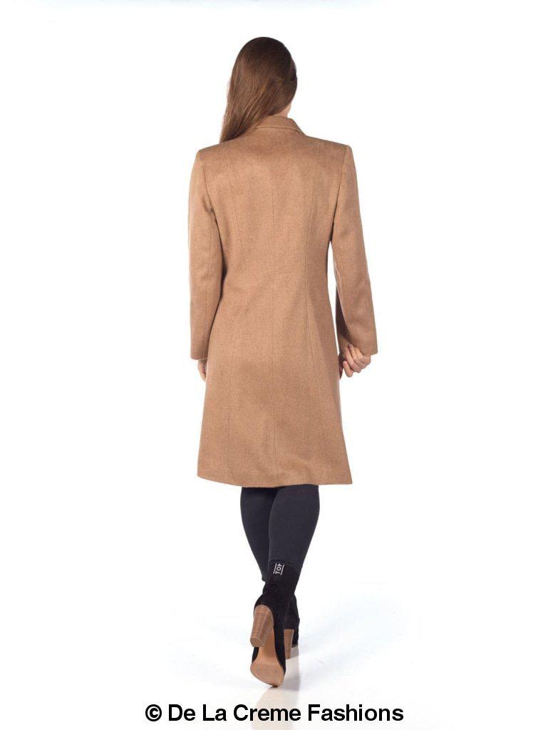 Woman wearing De La Creme mohair blend longline winter coat, viewed from the back, walking in beige coat and black tights.