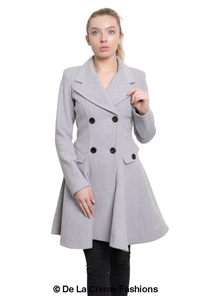 Woman modeling De La Creme Wool Blend Double Breasted Skater Coat in gray, featuring elegant button details and side pockets.