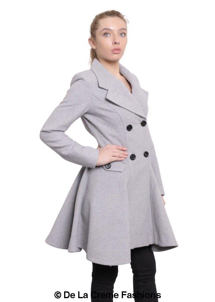 Woman modeling De La Creme Fashions Wool Blend Double Breasted Skater Coat in grey, showcasing elegant style and side pockets.