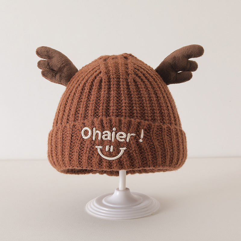 Brown knit baby hat with cute deer antlers design displayed on a stand, featuring playful "Ohaier!" embroidery on the front.