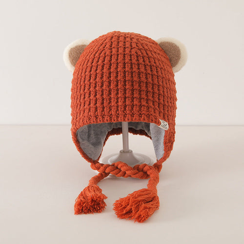 Orange plaid pattern warm balaclava for baby with cute ear details and soft lining, displayed on a stand