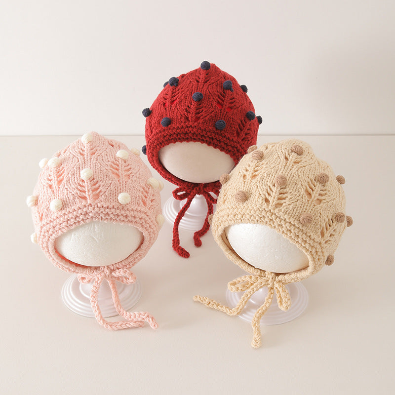 Three vintage design warm balaclavas for babies in red, pink, and beige with cute dot patterns displayed on a neutral background.