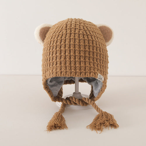 Cute baby balaclava with bear ears in brown plaid pattern, lined with grey fabric, displayed on a stand.