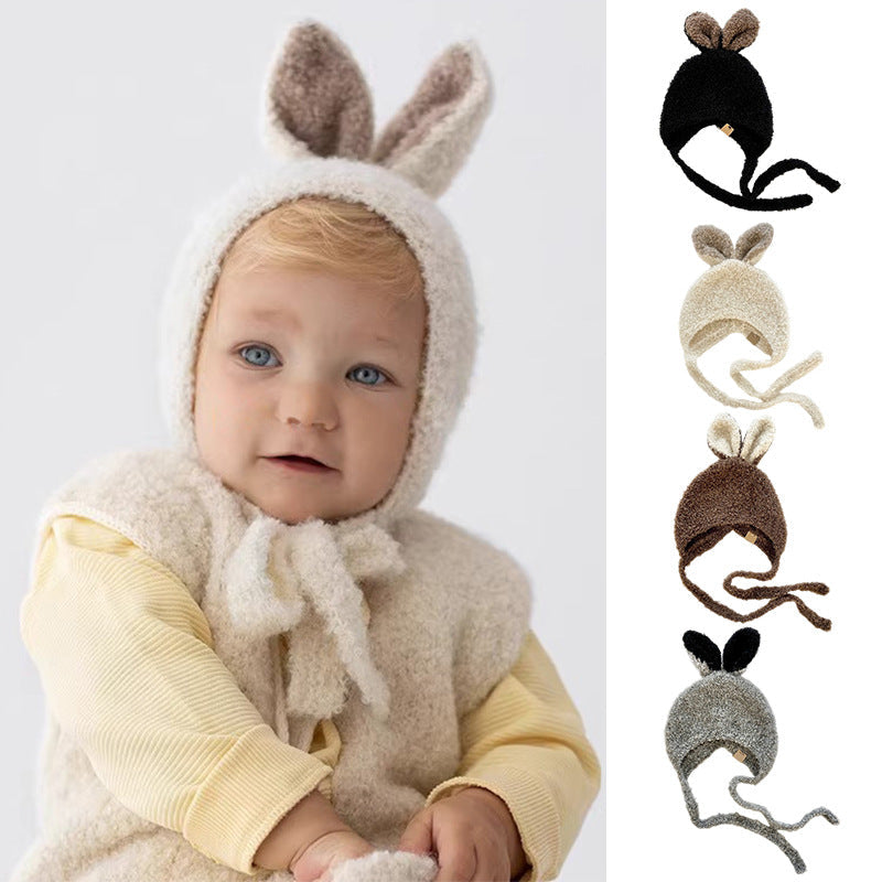 Baby wearing a warm fleece balaclava with rabbit ears design, in various color options available