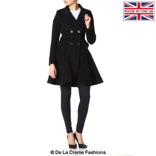 Woman modeling a black Wool Blend Double Breasted Skater Coat with side pockets, made in the UK, from De La Creme Fashions.