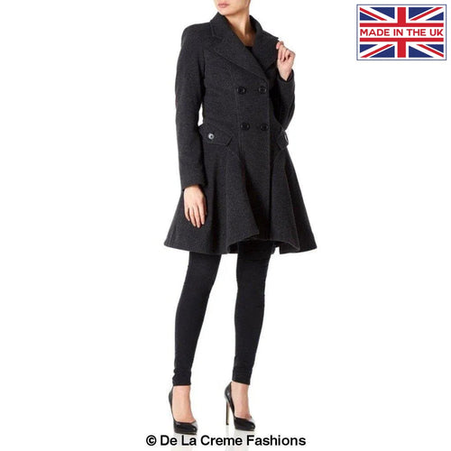 Woman modeling a Wool Blend Double Breasted Skater Coat by De La Creme Fashions, featuring side pockets and stylish fastening, made in the UK.